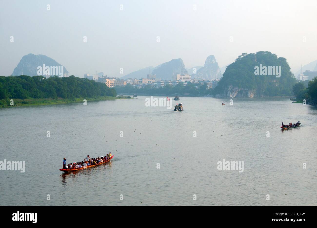 China: Dragon boats on the Li River, Guilin, Guangxi Province.  Guilin's Dragon Boat Festival is held on the fifth day of the fifth month (May) of the Chinese lunar calendar every 3 years. The festival was originally held in memory of the great Chinese poet, Quyuan.  The name Guilin means ‘Cassia Woods’ and is named after the osmanthus (cassia) blossoms that bloom throughout the autumn period.  Guilin is the scene of China’s most famous landscapes, inspiring thousands of paintings over many centuries. Stock Photo
