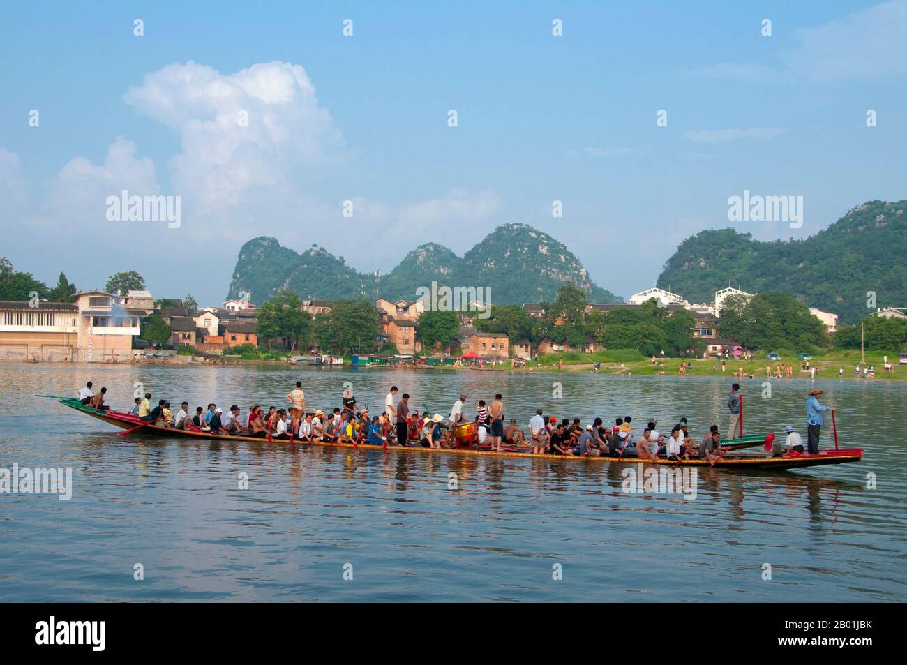 China: Dragon boats on the Li River with Seven Star Park in the background, Guilin, Guangxi Province.  Guilin's Dragon Boat Festival is held on the fifth day of the fifth month (May) of the Chinese lunar calendar every 3 years. The festival was originally held in memory of the great Chinese poet, Quyuan.  The name Guilin means ‘Cassia Woods’ and is named after the osmanthus (cassia) blossoms that bloom throughout the autumn period.  Guilin is the scene of China’s most famous landscapes, inspiring thousands of paintings over many centuries. Stock Photo
