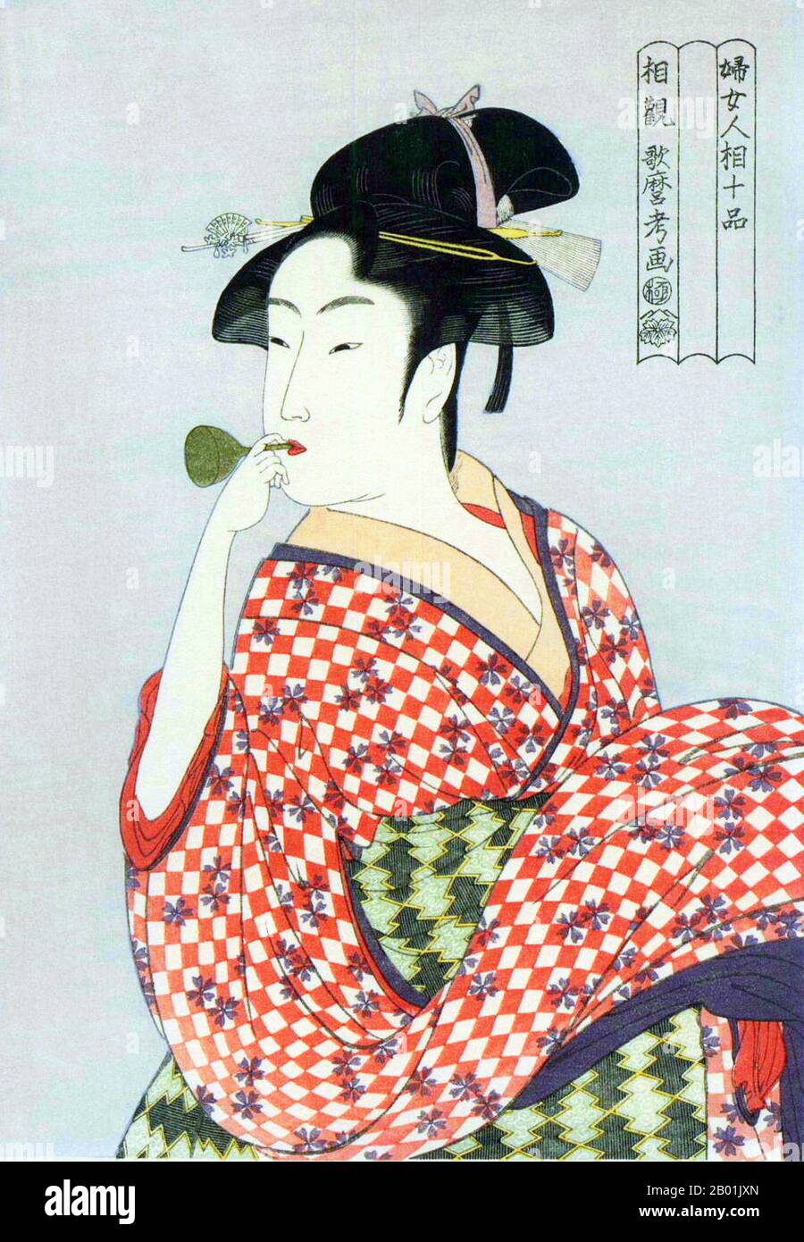 Japan: 'Young Woman Blowing a Glass Pipe'. Ukiyo-e woodblock print by Kitagawa Utamaro (c. 1753 - 31 October 1806), c. 1792-1793.  Kitagawa Utamaro was a Japanese printmaker and painter, who is considered one of the greatest artists of woodblock prints (ukiyo-e). He is known especially for his masterfully composed studies of women, known as bijinga. He also produced nature studies, particularly illustrated books of insects. Stock Photo