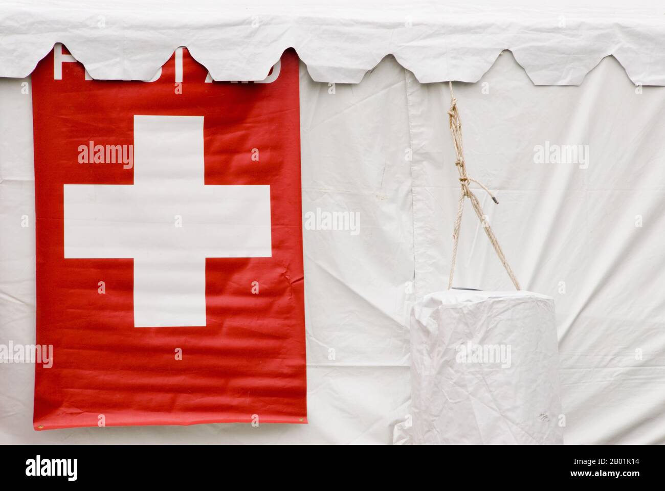 Outdoors public white colored first aid tent with a red cross on the side. Stock Photo