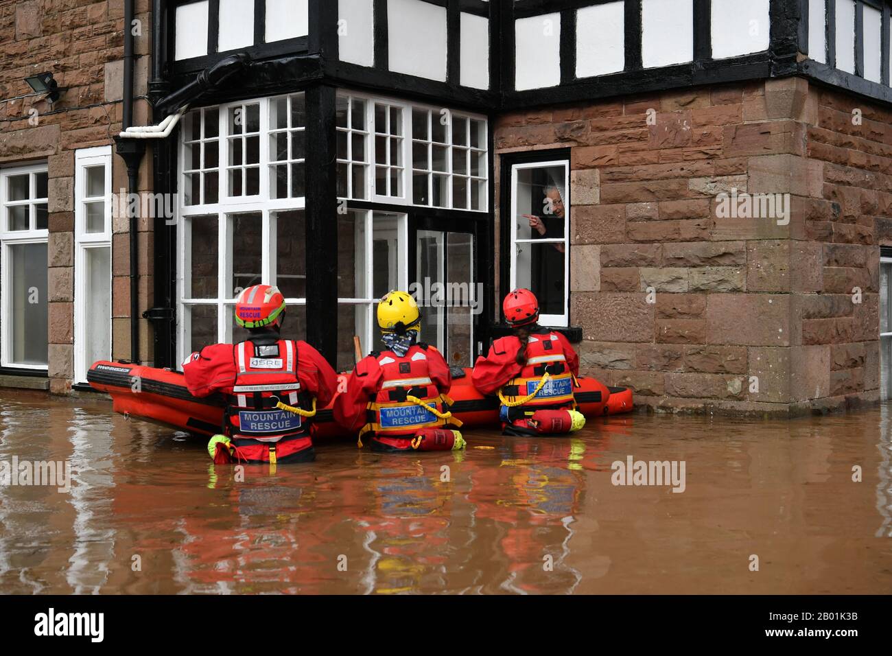 Mountain Rescue team members attempt to rescue a man from his house that is surrounded by heavy flood water in Monmouth, in the aftermath of Storm Dennis. Stock Photo