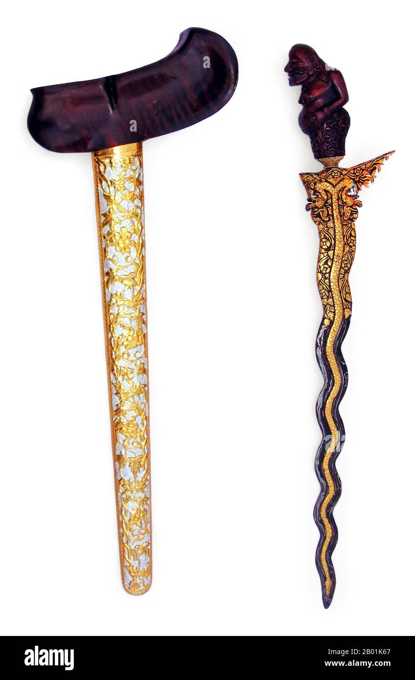 Indonesia: A gayaman-style kris, featuring Semar on the handle, floral etching on the sheath, and a dragon design on the blade. Probably from Solokarta, Java. Photo by Crisco 1492 (CC BY-SA 3.0 License).  Semar is a character in Javanese mythology who frequently appears in wayang shadow plays. He is one of the punokawan (clowns), but is in fact divine and very wise. He is the dhanyang (guardian spirit) of Java, and is regarded by some as the most sacred figure of the kotak (wayang set). He is said to be the god Sang Hyang Ismaya in human form. Stock Photo