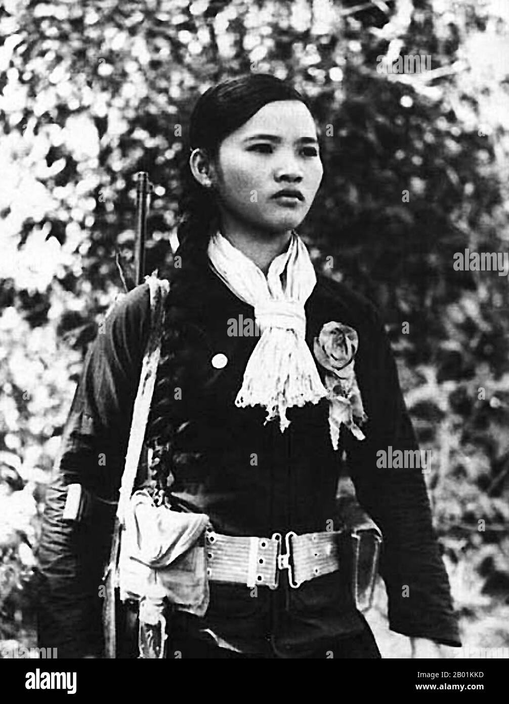 Vietnam: A female NLF (Viet Cong) guerrilla fighter, c. 1968.  The Second Indochina War, known in America as the Vietnam War, was a Cold War era military conflict that occurred in Vietnam, Laos, and Cambodia from 1 November 1955 to the fall of Saigon on 30 April 1975. This war followed the First Indochina War and was fought between North Vietnam, supported by its communist allies, and the government of South Vietnam, supported by the U.S. and other anti-communist nations.  The U.S. government viewed involvement in the war as a way to prevent a communist takeover of South Vietnam. Stock Photo
