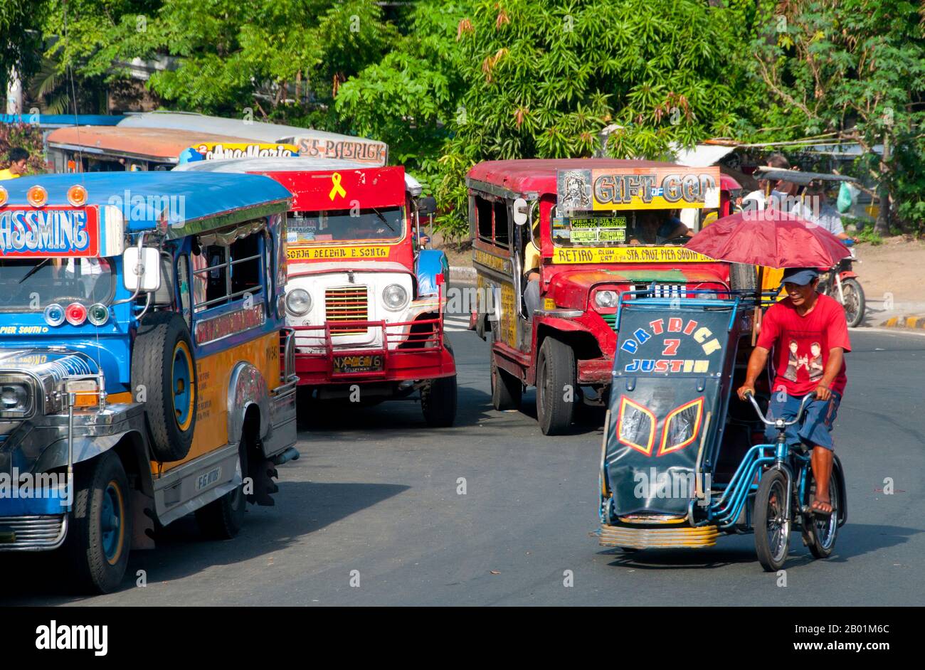 Philippines: Jeepneys and pedicab, Anda Circle, Bonifacio Drive, near Intramuros, Manila.  Jeepneys are the most popular means of public transportation in the Philippines. They were originally made from US military jeeps left over from World War II and are known for their flamboyant decoration and crowded seating. They have become a ubiquitous symbol of Philippine culture. Stock Photo