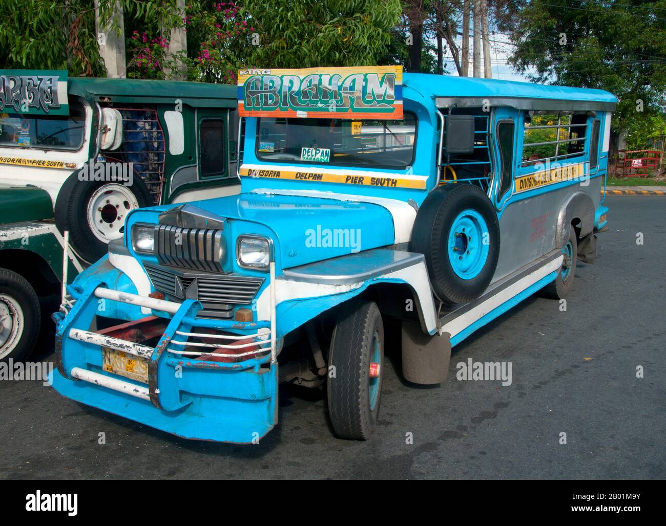 Philippines: Jeepney, Anda Circle, Bonifacio Drive, near Intramuros, Manila.  Jeepneys are the most popular means of public transportation in the Philippines. They were originally made from US military jeeps left over from World War II and are known for their flamboyant decoration and crowded seating. They have become a ubiquitous symbol of Philippine culture. Stock Photo