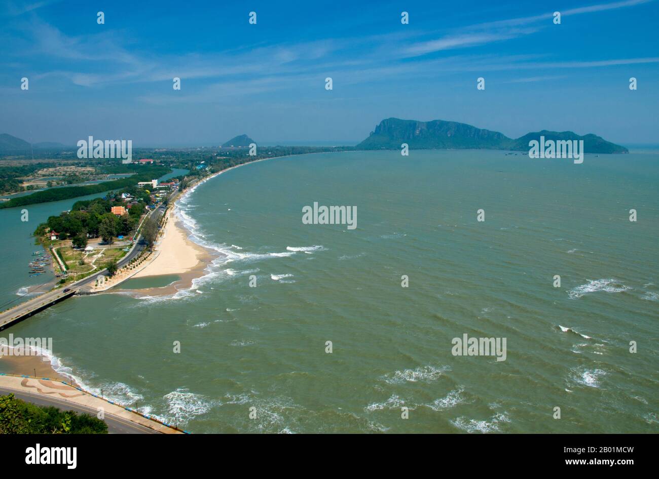 Thailand: Ao Bang Nang Rom (Bang Nang Rom Bay) seen from Khao Chong Krajok (Mirror Mountain), Prachuap Khiri Khan Province.  Bang Nang Rom Bay is located between Prachuap Khiri Khan and its satellite beach at Ao Noi. This prosperous Thai fishing village has a reputation for making excellent wooden fishing vessels by hand. Once finished, the boats are either sold to neighbouring fishing communities, or used by local fishermen to catch a prized local fish called ching chang, which is dried and then sold to South Asian buyers. Stock Photo