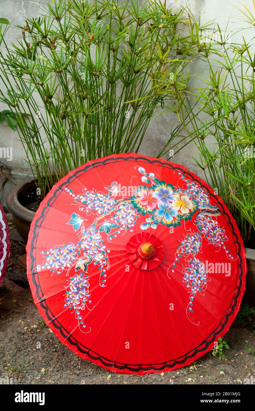 Thailand: Umbrella drying in the garden, Bo Sang Umbrella Village, near Chiang Mai, northern Thailand.  Bo Sang, near the northern Thai city of Chiang Mai, is famous for its hand-made brightly colored umbrellas and parasols. Once a year, in late January, the Bo Sang Umbrella and San Kamphaeng Handicrafts Festival is held in the town.  Chiang Mai (meaning 'new city'), sometimes written as 'Chiengmai' or 'Chiangmai', is the largest and most culturally significant city in northern Thailand. King Mengrai founded the city of Chiang Mai in 1296, and it succeeded Chiang Rai as capital. Stock Photo