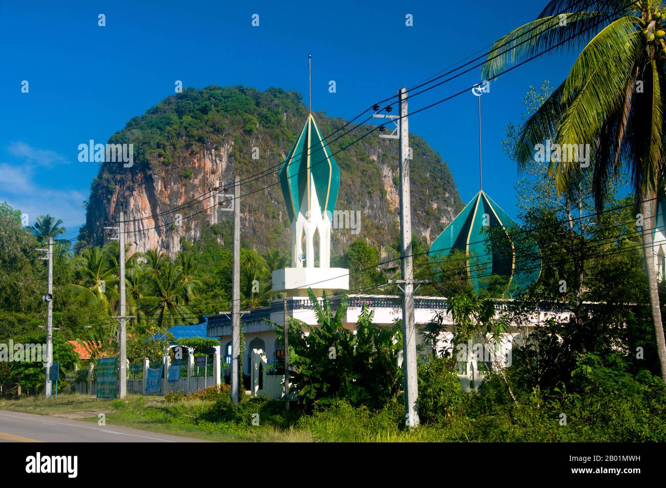 Thailand: Local mosque near Krabi Town, Krabi Coast.  Krabi Province is made up of more than 5,000 sq km of jungle-covered hills and sharp, jagged karst outcrops, as well as more than 100km of luxuriant, pristine coastline and around 200 islands in the neighbouring Andaman Sea.  About 40 per cent of the provincial population is Muslim, the remainder being predominantly Buddhist. This is a clear indication that Krabi sits astride the invisible dividing line between Buddhist Thailand and the four southern provinces - Satun, Narathiwat, Yala and Pattani - which are predominantly Muslim. Stock Photo