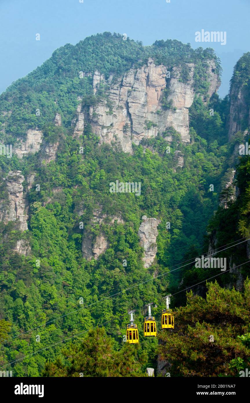 China: Cable car, Wulingyuan Scenic Area (Zhangjiajie), Hunan Province.  Wulingyuan Scenic Reserve is a scenic and historic interest area in Hunan Province. It is noted for its approximately 3,100 tall quartzite sandstone pillars, some of which are over 800 metres (2,600 ft) in height and are a type of karst formation. In 1992 it was designated a UNESCO World Heritage Site. Stock Photo