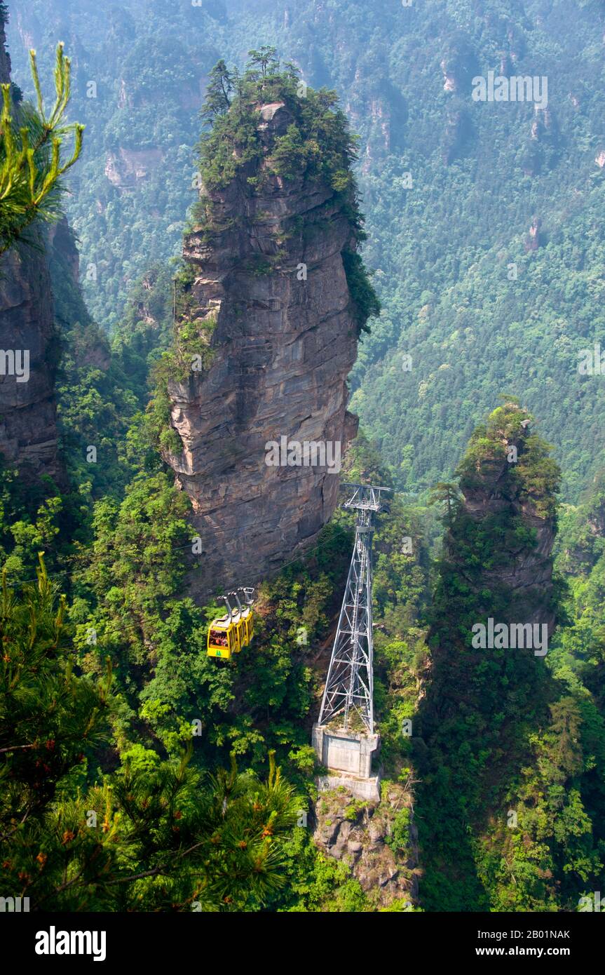 China: Cable car, Wulingyuan Scenic Area (Zhangjiajie), Hunan Province.  Wulingyuan Scenic Reserve is a scenic and historic interest area in Hunan Province. It is noted for its approximately 3,100 tall quartzite sandstone pillars, some of which are over 800 metres (2,600 ft) in height and are a type of karst formation. In 1992 it was designated a UNESCO World Heritage Site. Stock Photo