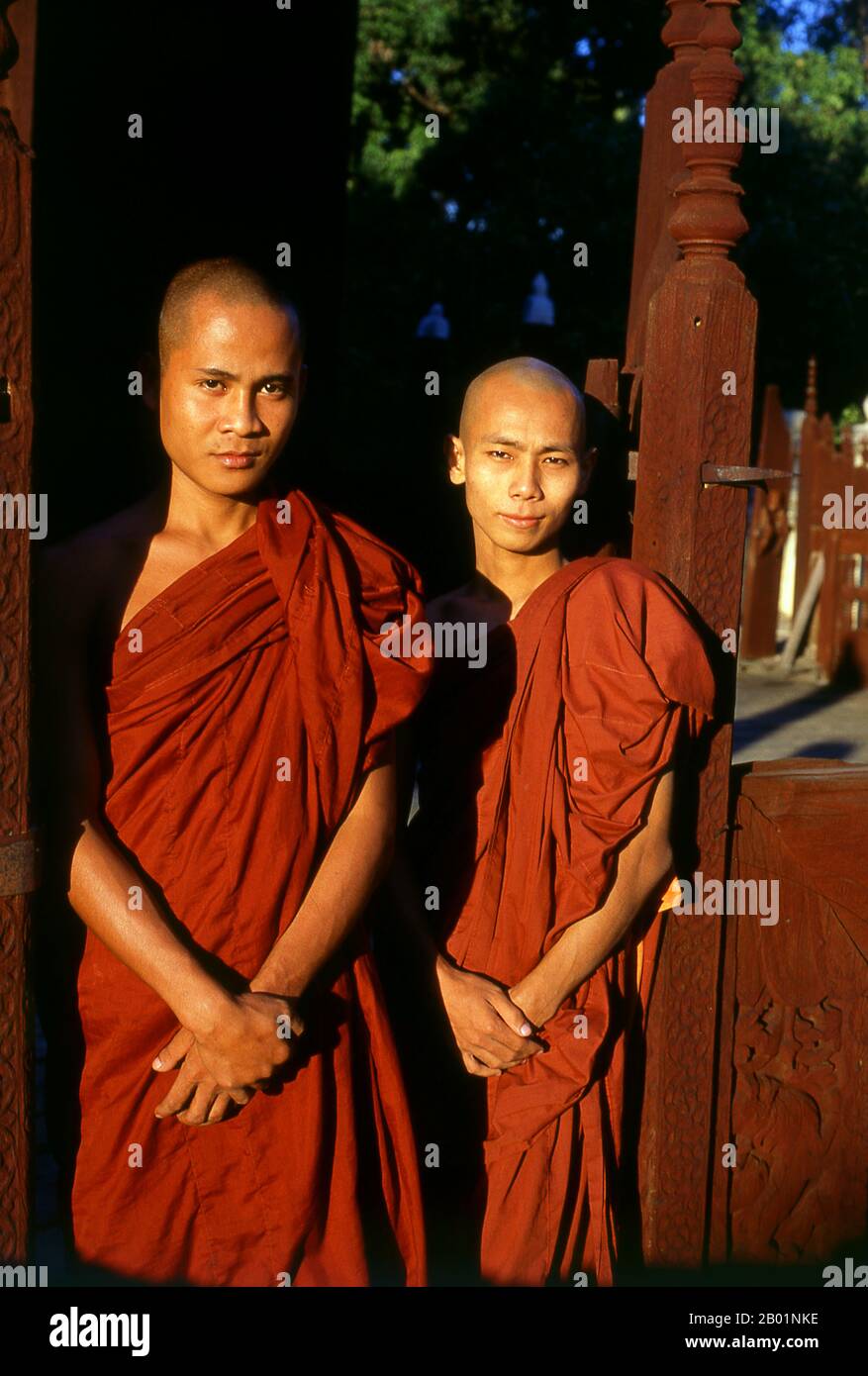 Burma/Myanmar: Two young monks at Shwe In Bin Kyaung (temple), Mandalay.  Mandalay, a sprawling city of more than 1 million people, was founded in 1857 by King Mindon to coincide with an ancient Buddhist prophecy. It was believed that Gautama Buddha visited the sacred mount of Mandalay Hill with his disciple Ananda, and proclaimed that on the 2,400th anniversary of his death, a metropolis of Buddhist teaching would be founded at the foot of the hill. Stock Photo