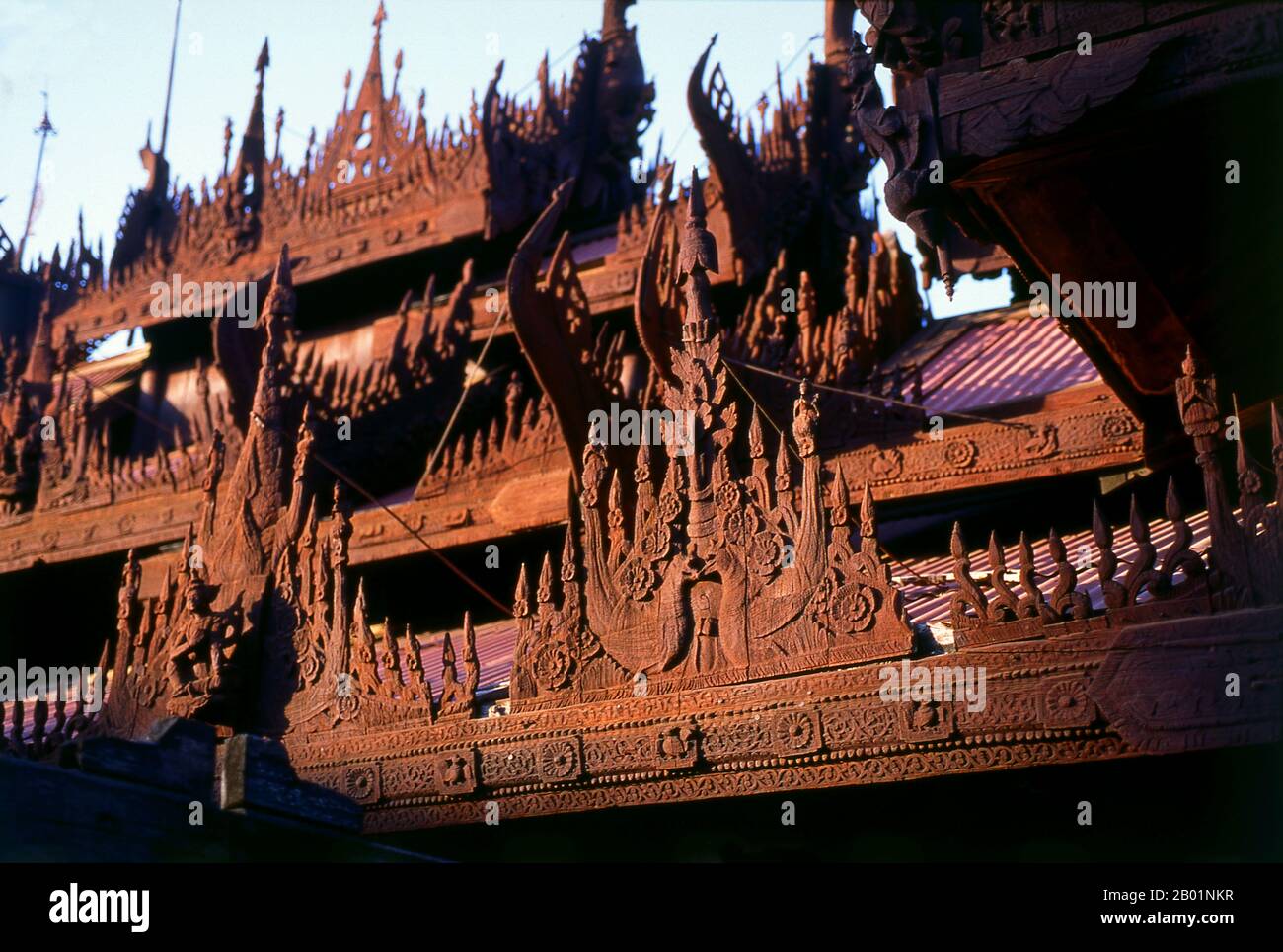 Burma/Myanmar: Roof detail, Shwe In Bin Kyaung, Mandalay.  Mandalay, a sprawling city of more than 1 million people, was founded in 1857 by King Mindon to coincide with an ancient Buddhist prophecy. It was believed that Gautama Buddha visited the sacred mount of Mandalay Hill with his disciple Ananda, and proclaimed that on the 2,400th anniversary of his death, a metropolis of Buddhist teaching would be founded at the foot of the hill. Stock Photo