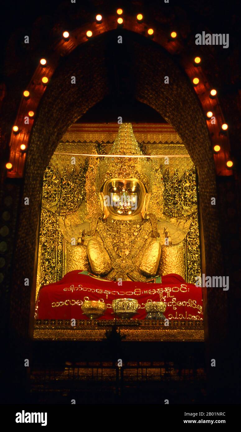 Burma/Myanmar: The Maha Muni image, Maha Muni Pagoda, Mandalay.  The Mahamuni Buddha Temple, also called the Mahamuni Pagoda, is a Buddhist temple and major pilgrimage site, located southwest of Mandalay, Burma (Myanmar). The Mahamuni Buddha image (literal meaning: The Great Sage) is deified in this temple, and originally came from Arakan. It is highly venerated in Burma and central to many people's lives, as it is seen as an expression of representing the Buddha's life. Stock Photo