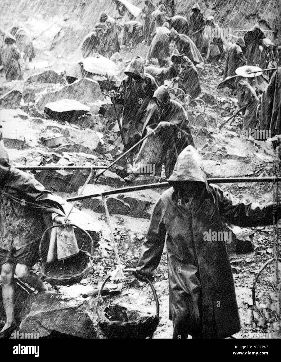 China: Hard labour in the rain during the Great Leap Forward (1958-1961).  The Great Leap Forward of the People's Republic of China (PRC) was an economic and social campaign of the Communist Party of China (CPC), reflected in planning decisions from 1958 to 1961, which aimed to use China's vast population to rapidly transform the country from an agrarian economy into a modern communist society through the process of rapid industrialisation, and collectivisation. Mao Zedong led the campaign based on the Theory of Productive Forces. Stock Photo