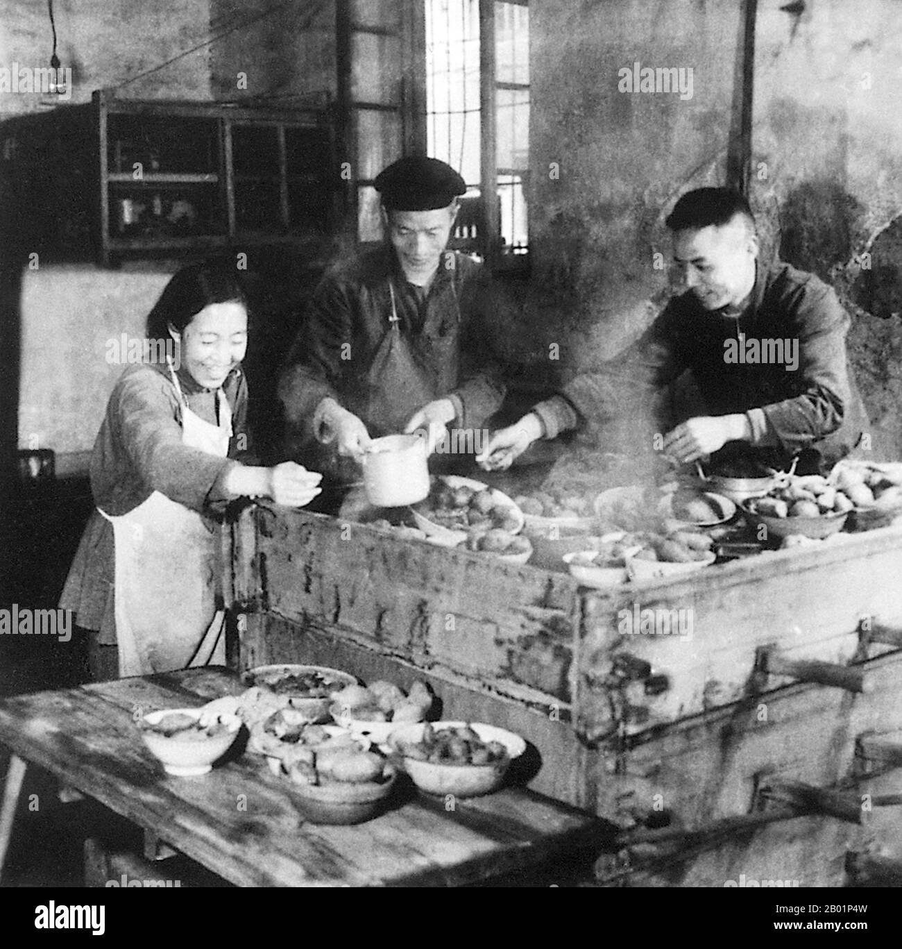China: Workers preparing food in a communal kitchen during the Great Leap Forward (1958-1961).  The Great Leap Forward of the People's Republic of China (PRC) was an economic and social campaign of the Communist Party of China (CPC), reflected in planning decisions from 1958 to 1961, which aimed to use China's vast population to rapidly transform the country from an agrarian economy into a modern communist society through the process of rapid industrialisation, and collectivisation. Mao Zedong led the campaign based on the Theory of Productive Forces. Stock Photo