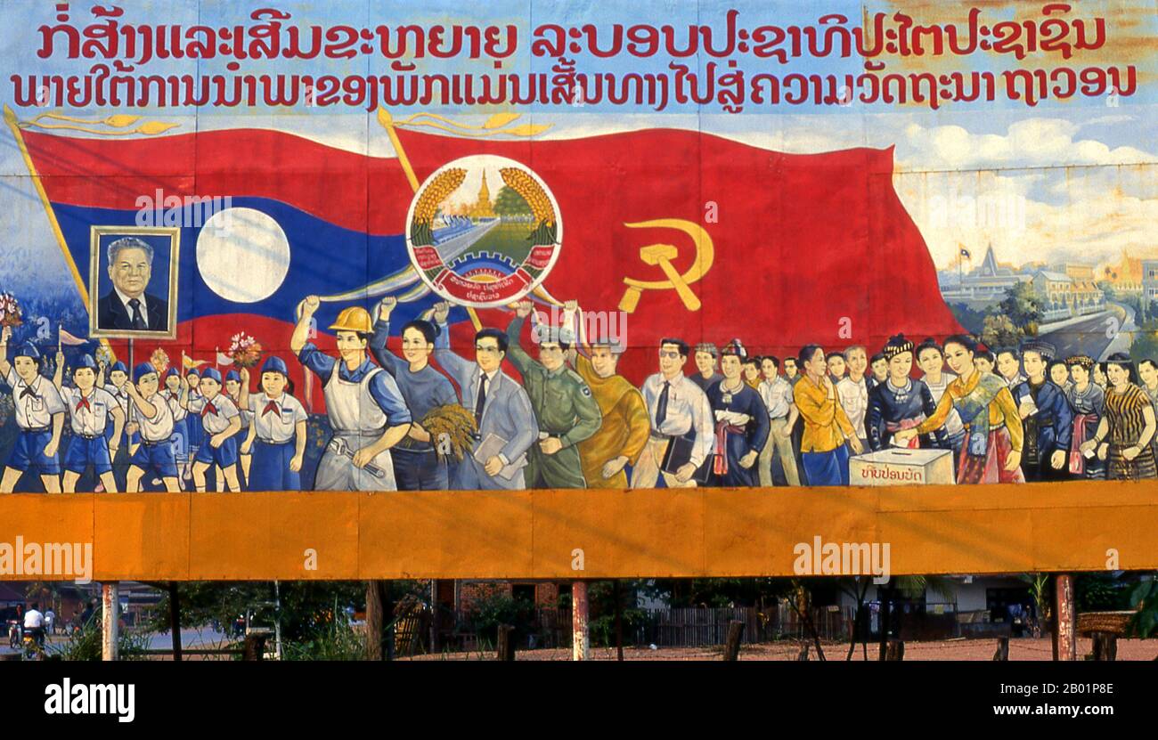 Laos: Children carry an image of Kaysone Phomvihane, former President of Laos. Revolutionary Socialist realist-style political poster on the streets of Vientiane.  Kaysone Phomvihane (13 December 1920 - 21 November 1992) was the leader of the Lao People's Revolutionary Party from 1955. He served as the first Prime Minister of the Lao People's Democratic Republic from 1975 to 1991 and then as President from 1991 until his death in 1992.  Socialist realism is a style of realistic art which was developed in the Soviet Union and became a dominant style in other communist countries. Stock Photo