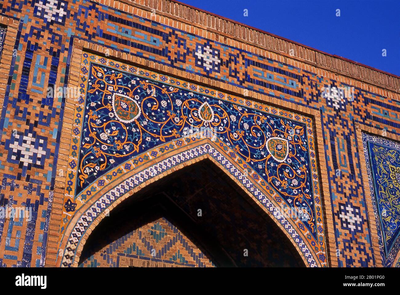 Uzbekistan: Intricate arabesque decorations in the inner courtyard of Tillya Kari Madrassa, The Registan, Samarkand.  The Registan contains three madrasahs (schools), the Ulugh Beg Madrasah (1417-1420), Tilya-Kori Madrasah (1646-1660) and the Sher-Dor Madrasah (1619-1636).  The Tilya-Kori Madrasah was built in the mid-17th century by the Shaybanid Amir Yalangtush. The name Tilya-Kori means ‘gilded’ or ‘gold-covered’, and the entire building is lavishly decorated with elaborate geometrical arabesques and sura from the Qur’an both outside and especially within. Stock Photo