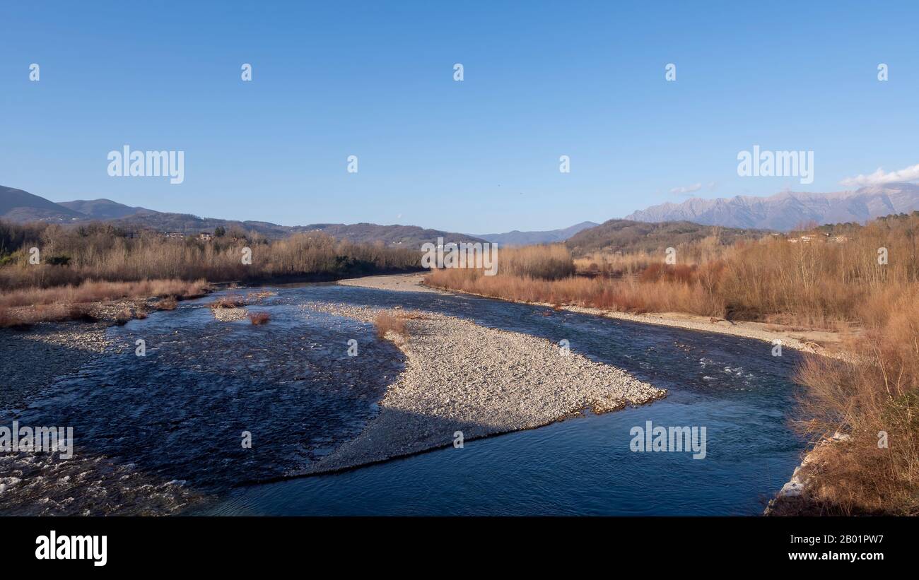 Lunigiana winter landscape view near Aulla. Magra River and mountains behind. Stock Photo