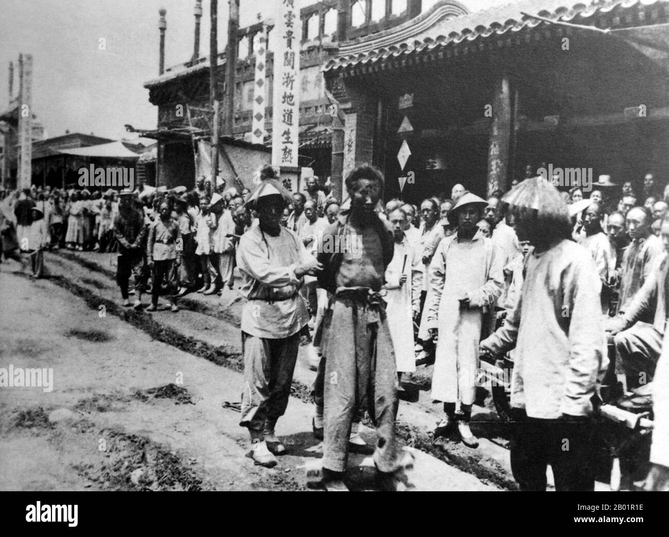 China: A boxer soldier captured by Qing troops, Beijing, c. 1900.  The Boxer Rebellion, also known as Boxer Uprising or Yihetuan Movement, was a proto-nationalist movement by the Righteous Harmony Society in China between 1898 and 1901, opposing foreign imperialism and Christianity.  The uprising took place in response to foreign spheres of influence in China, with grievances ranging from opium traders, political invasion, economic manipulation, to missionary evangelism. In China, popular sentiment remained resistant to foreign influences, and anger rose over the 'unequal treaties'. Stock Photo