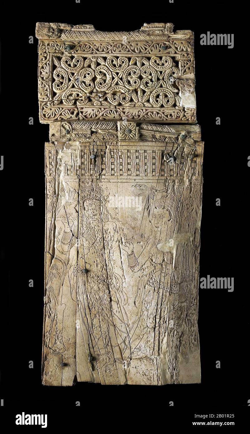 Afghanistan: Plaque with engraved girl playing a flute and a woman at the foot of a tree. Bagram, 1st-2nd century CE  In the 320s BCE, Alexander the Great captured the city of Bagram and established a fortified colony named Alexandria of the Caucasus. The new town had brick walls reinforced with towers at the angles. The central street was bordered with shops and workshops.  After his death in 323 BCE, the city passed to his general Seleucus, who traded it to the Mauryan Dynasty of India in 305 BCE. Stock Photo