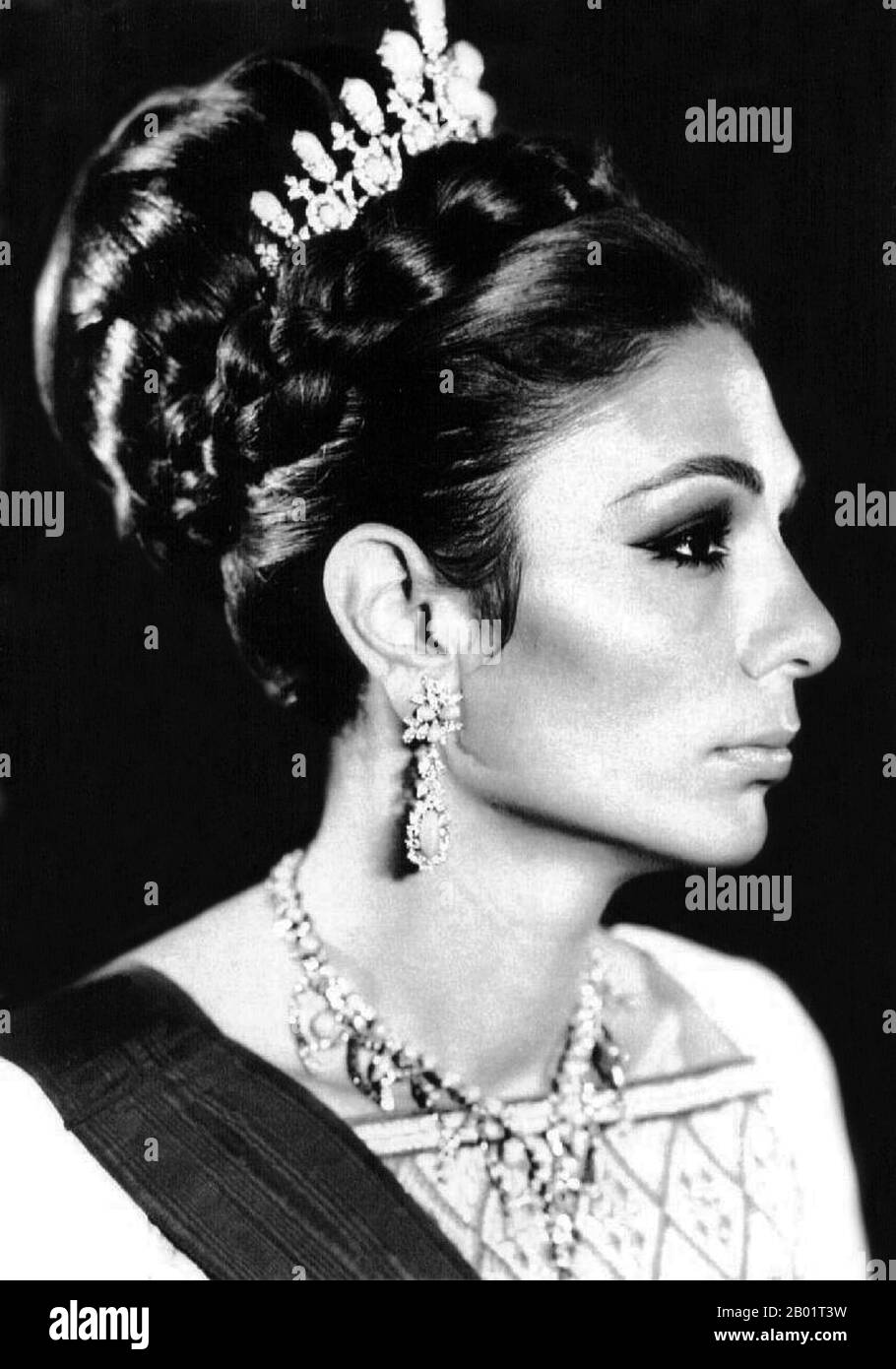 Iran/Persia: Official portrait of Empress Farah Pahlavi (1938-), wife and widow of Mohammad Reza Pahlavi, the Shah of Iran (1919-1979), c. 1970s.  Farah Pahlavi (born Farah Diba) is the former Queen and Empress of Iran. She is the widow of Mohammad Reza Pahlavi, the Shah of Iran, and only Empress of modern Iran. She was Queen Consort of Iran from 1959 until 1967 and Empress Consort from 1967 until exile in 1979.  Though the titles and distinctions of the Iranian Imperial Family were abolished within Iran by the Islamic government, she is still styled Empress or Shahbanou, out of courtesy. Stock Photo