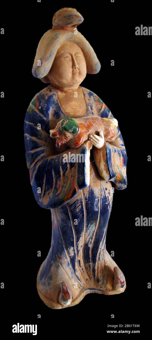 China: Sancai ceramic figurine of a lady holding a small dog, Tang Dynasty (618-907). Photo by VK Cheong (CC BY-SA 3.0 License).  Sancai (pinyin: sāncǎi; literally 'three colours') is a type of ceramics using three intermingled colours for decoration. The sancai technique dates back to the Tang Dynasty. Stock Photo