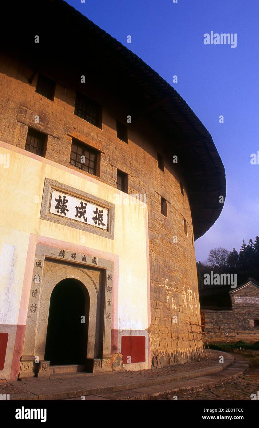 China: Zhenchang Lou Hakka Tower near Hukeng, Yongding County, Fujian Province.  The Hakka (kejia in Mandarin; literally 'guest people') are Han Chinese who speak the Hakka language. Their distinctive earthen houses or tulou can be found in the borderland counties where Guangdong, Jiangxi and Fujian provinces meet.  Communal entities, tulou are fortified against marauding bandits and generally made of compacted earth, bamboo, wood and stone. They contain many rooms on several storeys, so that several families can live together. Stock Photo