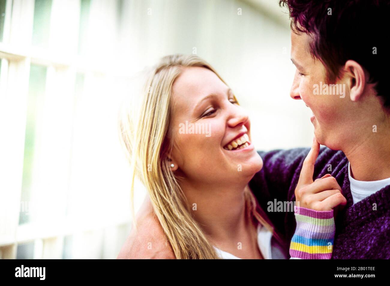 Happy Young Couple, Young Woman's finger on Young Man's chin Stock Photo