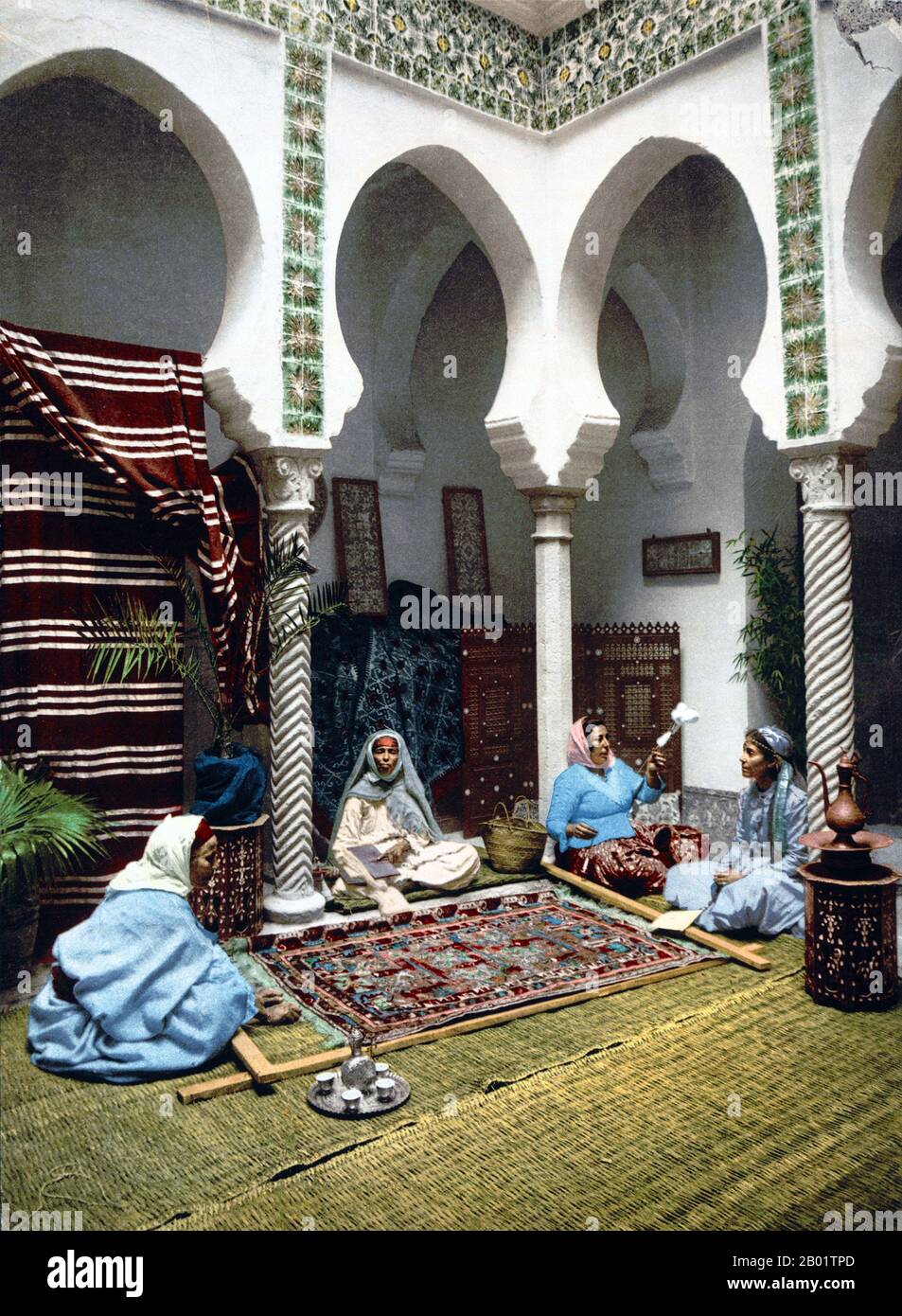 Algeria: Moorish women making Arab carpets, Algiers, 1899.  An authentic oriental rug is a handmade carpet that is either knotted with pile or woven without pile.  By definition - Oriental rugs are rugs that come from the orient. The simple definition of the term would be - rugs that come from (were made in) an Asian Country such as: China and Vietnam in the east to Turkey, Maghreb countries, Cyprus and Iran in the west and the Caucasus in the north to India in the south. Stock Photo