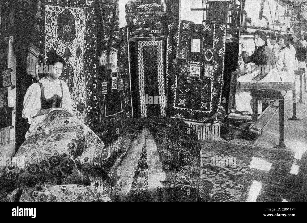 Bosnia/Turkey: Women carpet weavers, Sarajevo, Ottoman Bosnia, c. 1905.  An authentic oriental rug is a handmade carpet that is either knotted with pile or woven without pile.  By definition - Oriental rugs are rugs that come from the orient. The simple definition of the term would be - rugs that come from (were made in) an Asian Country such as: China and Vietnam in the east to Turkey, Maghreb countries, Cyprus and Iran in the west and the Caucasus in the north to India in the south. Stock Photo