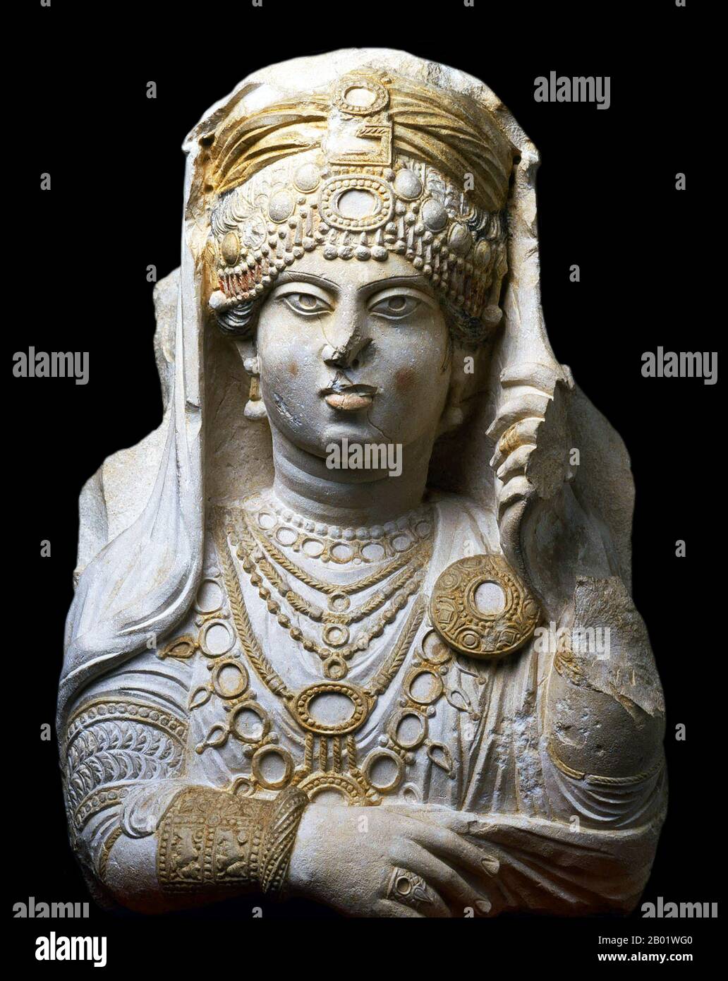 Syria: Limestone funerary bust of a woman known to posterity as 'The Beauty of Palmyra', c. 190-210 CE  Palmyra was an ancient city in Syria. It was an important city in central Syria, located in an oasis 215 km northeast of Damascus and 180 km southwest of the Euphrates at Deir ez-Zor. It had long been a vital caravan city for travellers crossing the Syrian desert and was known as the Bride of the Desert. The earliest documented reference to the city is by its Semitic name Tadmor, Tadmur or Tudmur (which means 'the town that repels' in Amorite and 'the indomitable town' in Aramaic). Stock Photo