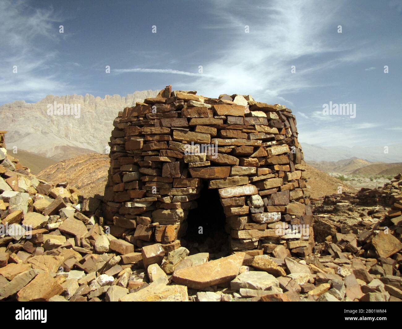 Oman: Ancient stone tomb at Al Ayn, near Bat, c. 3500-2500 BCE.  The earliest stone-built tombs which can be called 'beehive', are in Oman, built of stacked flat stones which occur in nearby geological formations. They date to between 3500 and 2500 years BCE, to a period when the Arabian peninsula was subject to much more rainfall than now, and supported a flourishing civilisation in what is now desert, to the west of the mountain range along the Gulf of Oman.  No burial remains have ever been retrieved from these 'tombs', though there seems no other purpose for their building. Stock Photo