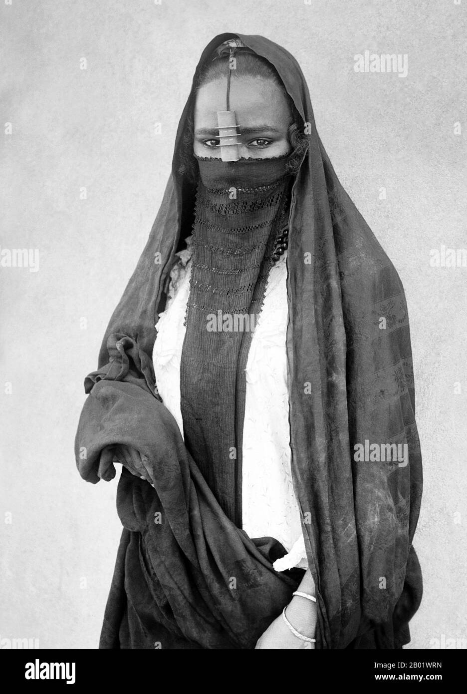 Egypt: A native veiled woman, Cairo, c. 1860-1890.  Egyptian culture has six thousand years of recorded history. Ancient Egypt was among the earliest civilisations and for millennia, Egypt maintained a strikingly complex and stable culture that influenced later cultures of Europe, the Middle East and other African countries.  After the Pharaonic era, Egypt itself came under the influence of Hellenism, Christianity and Islamic culture. Today, many aspects of Egypt's ancient culture exist in interaction with newer elements, including the influence of modern Western culture. Stock Photo