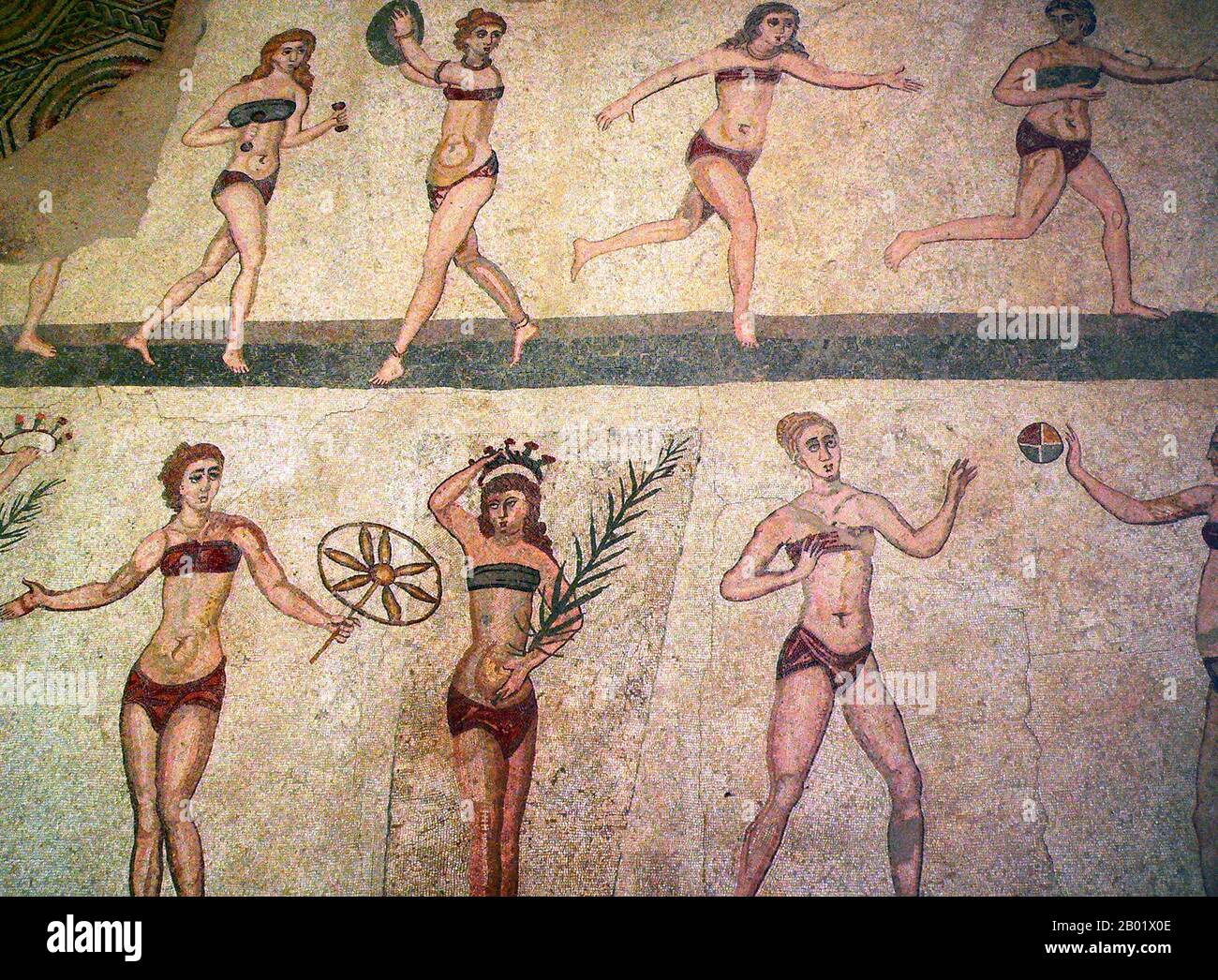 Italy: Roman women playing with a ball in a mosaic at Villa Romana del Casale. One of the so-called 'Bikini Mosaics', 4th century CE. Photo by M. Disdero (CC BY-SA 3.0 License).  Villa Romana del Casale (Sicilian: Villa Rumana dû Casali) is a Roman villa built in the first quarter of the 4th century CE and located about 5 km outside the town of Piazza Armerina, Sicily, southern Italy. Containing the richest, largest and most complex collection of Roman mosaics in the world, it is one of 44 UNESCO World Heritage Sites in Italy. Stock Photo