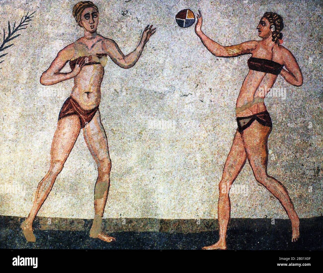 Italy: Roman women playing with a ball in a mosaic at Villa Romana del Casale. One of the so-called 'Bikini Mosaics', 4th century CE.  Villa Romana del Casale (Sicilian: Villa Rumana dû Casali) is a Roman villa built in the first quarter of the 4th century CE and located about 5 km outside the town of Piazza Armerina, Sicily, southern Italy. Containing the richest, largest and most complex collection of Roman mosaics in the world, it is one of 44 UNESCO World Heritage Sites in Italy. Stock Photo