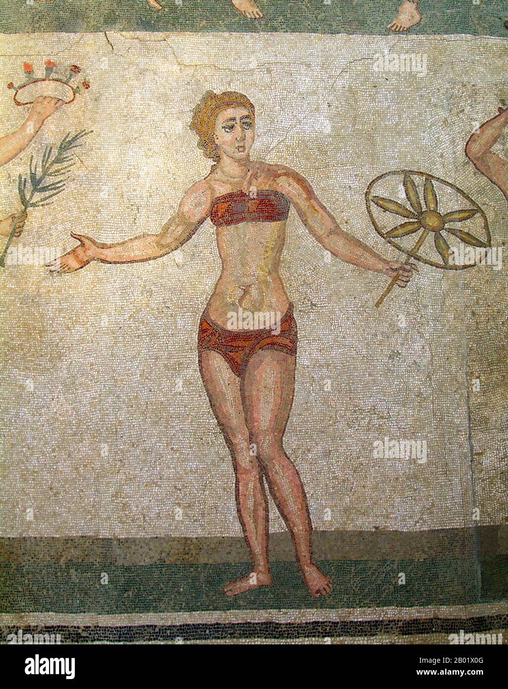 Italy: Roman women playing with a ball in a mosaic at Villa Romana del Casale. One of the so-called 'Bikini Mosaics', 4th century CE. Photo by Pavel Krok (CC BY-SA 3.0 License).  Villa Romana del Casale (Sicilian: Villa Rumana dû Casali) is a Roman villa built in the first quarter of the 4th century CE and located about 5 km outside the town of Piazza Armerina, Sicily, southern Italy. Containing the richest, largest and most complex collection of Roman mosaics in the world, it is one of 44 UNESCO World Heritage Sites in Italy. Stock Photo