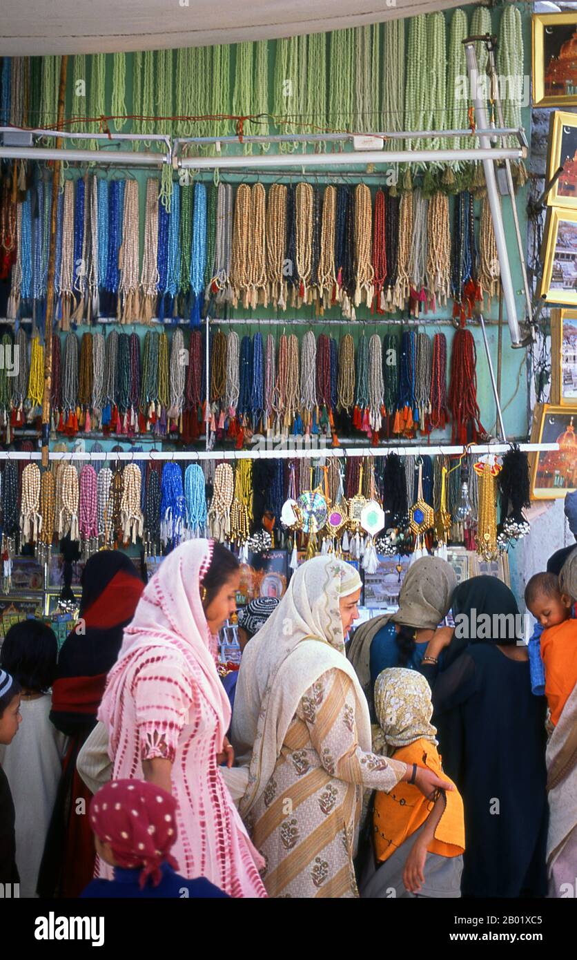India: A bangle and bead shop next to the Dargah Sharif of Sufi saint Moinuddin Chishti, Ajmer, Rajasthan.  Sultan-ul-Hind, Moinuddin Chishti (1141-1230), also known as Gharīb Nawāz ('Benefactor of the Poor'), was the most famous Sufi saint of the Chishti Order of the Indian Subcontinent. He introduced and established the order in South Asia.  Ajmer (Sanskrit: Ajayameru) was founded in the late 7th century CE by Dushyant Chauhan. The Chauhan dynasty ruled Ajmer in spite of repeated invasions by Turkic marauders from Central Asia across the north of India. Ajmer was conquered in 1193. Stock Photo