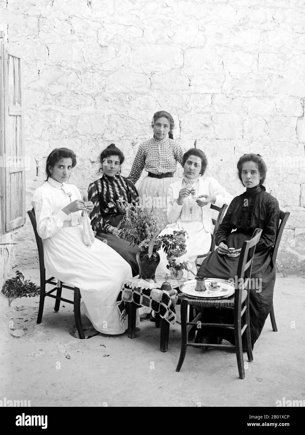 Palestine: A Middle class family enjoying afternoon coffee, Jerusalem, c. 1910.  Palestine is a name given to the geographic region between the Mediterranean Sea and the Jordan River. The region is also known as the Land of Israel, the Holy Land and the Southern Levant.  In 1832 Palestine was conquered by Muhammad Ali's Egypt, but in 1840 Britain intervened and returned control of the Levant to the Ottomans in return for further capitulations. The end of the 19th century saw the beginning of Zionist immigration and the Revival of the Hebrew language. Stock Photo