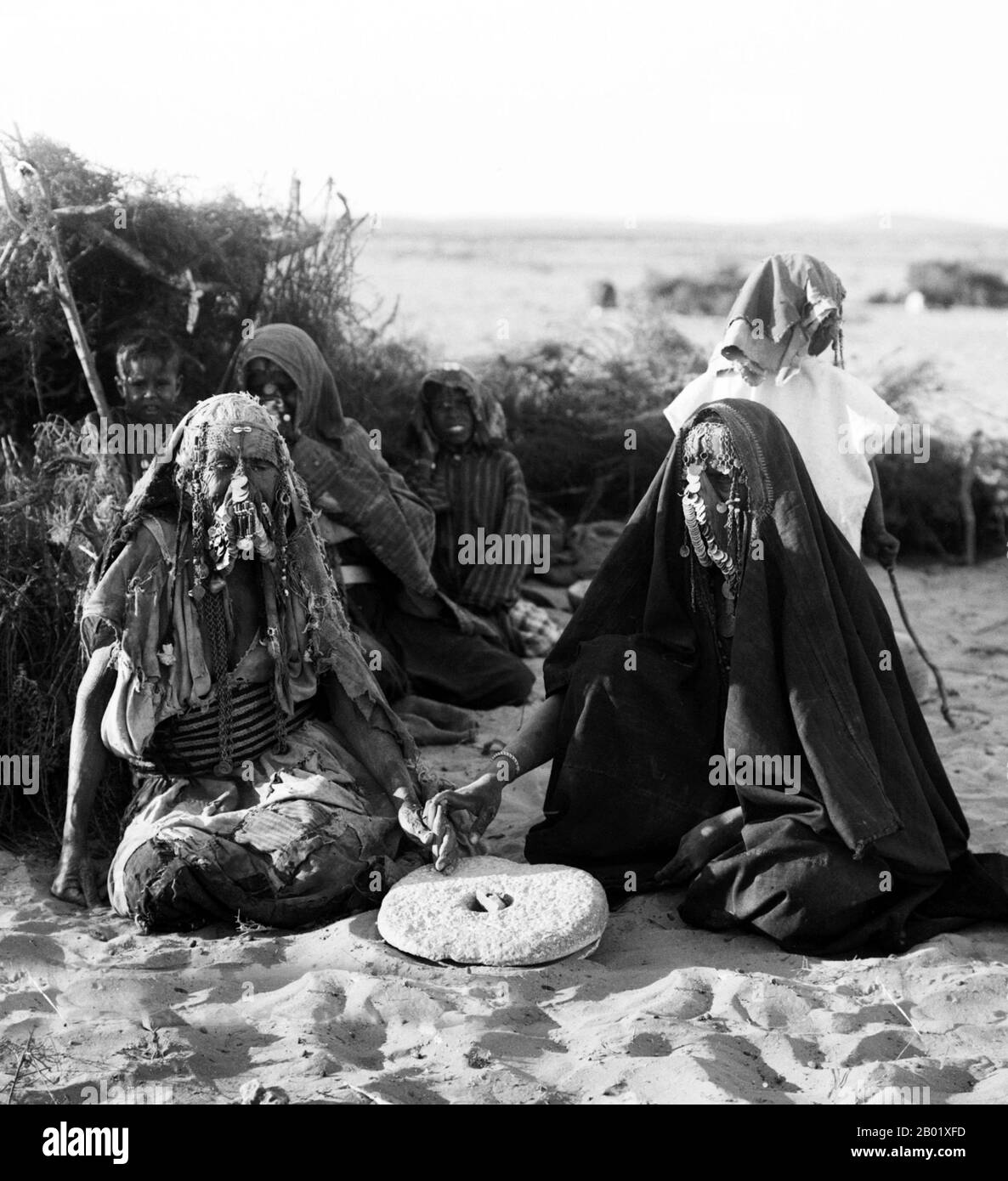 Palestine: Bedouin women grinding grain near Beersheba (Be'er Sheva, Bi'r as-Sab), c. 1900-1920.  Palestine is a name given to the geographic region between the Mediterranean Sea and the Jordan River. The region is also known as the Land of Israel, the Holy Land and the Southern Levant.  In 1832 Palestine was conquered by Muhammad Ali's Egypt, but in 1840 Britain intervened and returned control of the Levant to the Ottomans in return for further capitulations. The end of the 19th century saw the beginning of Zionist immigration and the Revival of the Hebrew language. Stock Photo