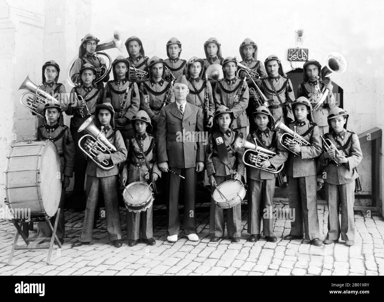 Palestine: A Palestinian band at a Jerusalem orphanage, c. 1918-1920.  Palestine is a name given to the geographic region between the Mediterranean Sea and the Jordan River. The region is also known as the Land of Israel, the Holy Land and the Southern Levant.  In 1832 Palestine was conquered by Muhammad Ali's Egypt, but in 1840 Britain intervened and returned control of the Levant to the Ottomans in return for further capitulations. The end of the 19th century saw the beginning of Zionist immigration and the Revival of the Hebrew language. Stock Photo