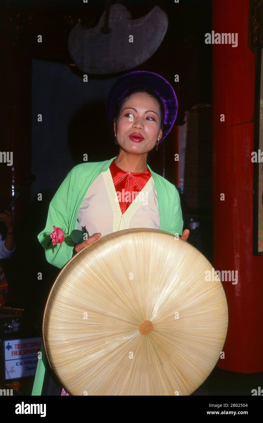 Vietnam: Singer with a traditional Vietnamese orchestra at Van Mieu (the Temple of Literature), Hanoi.  Vietnam has a long tradition of music and theatre that combines indigenous and foreign influences. The earliest known instruments are the frog drums of the Dong Son Period from around 250 BCE. This was followed by a millennium of immersion in Chinese cultural traditions which remains very apparent.  In 981, after the reassertion of national independence, King Le Dai Hanh invaded neighbouring Champa and carried the royal court dancers and musicians back to his capital. Stock Photo