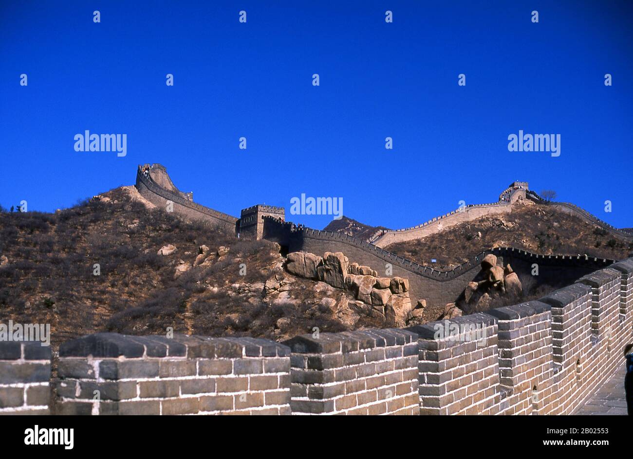 The Great Wall (Wanli Changcheng) is one of mankind's greatest achievements and dates back more than two millennia, when a series of shorter walls were systematically linked during the Qin dynasty (221–206 BCE) to protect China’s northern borders.  The Wall, originally built to keep out barbarian invaders from the north, stretches more than 5,900km (3,700 miles) from the Bohai Gulf in the Yellow Sea to Jiayuguan in the mountains of Gansu province. While the bulk of the wall is now in ruins, some sections have been repaired in recent years.  The Ming rulers, who in 1368 put an end to the alien Stock Photo