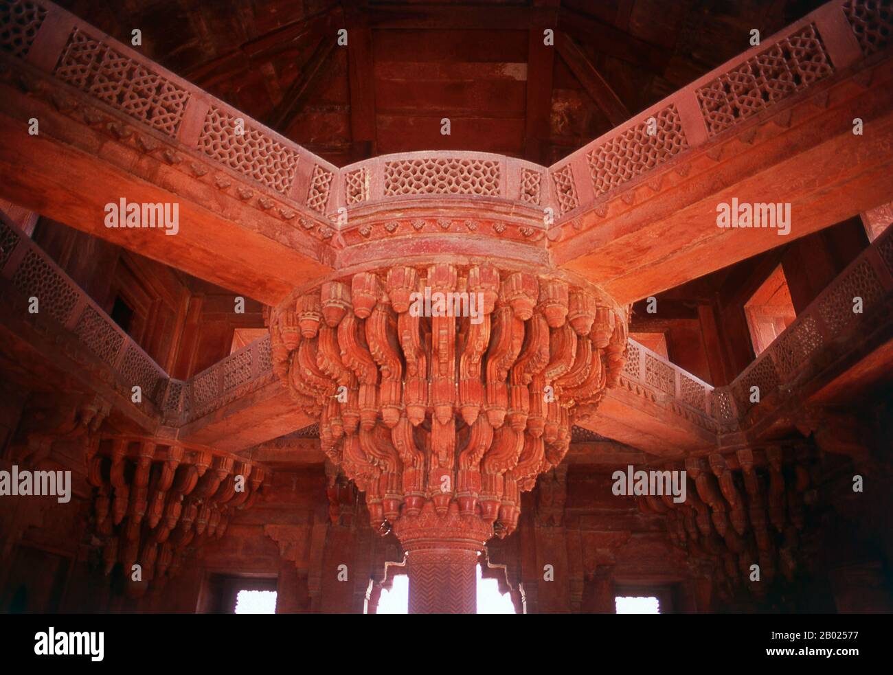 The Diwan-i-Khas, or Hall of Private Audience, is a plain square building with four chhatris on the roof. It is famous for its central pillar, which has a square base and an octagonal shaft, both carved with bands of geometric and floral designs, further its thirty-six serpentine brackets support a circular platform for the Mughal emperor Akbar, which is connected to each corner of the building on the first floor, by four stone walkways. It is here that Akbar had representatives of different religions discuss their faiths and gave private audience.  Fatehpur Sikri (the City of Victory) was bui Stock Photo