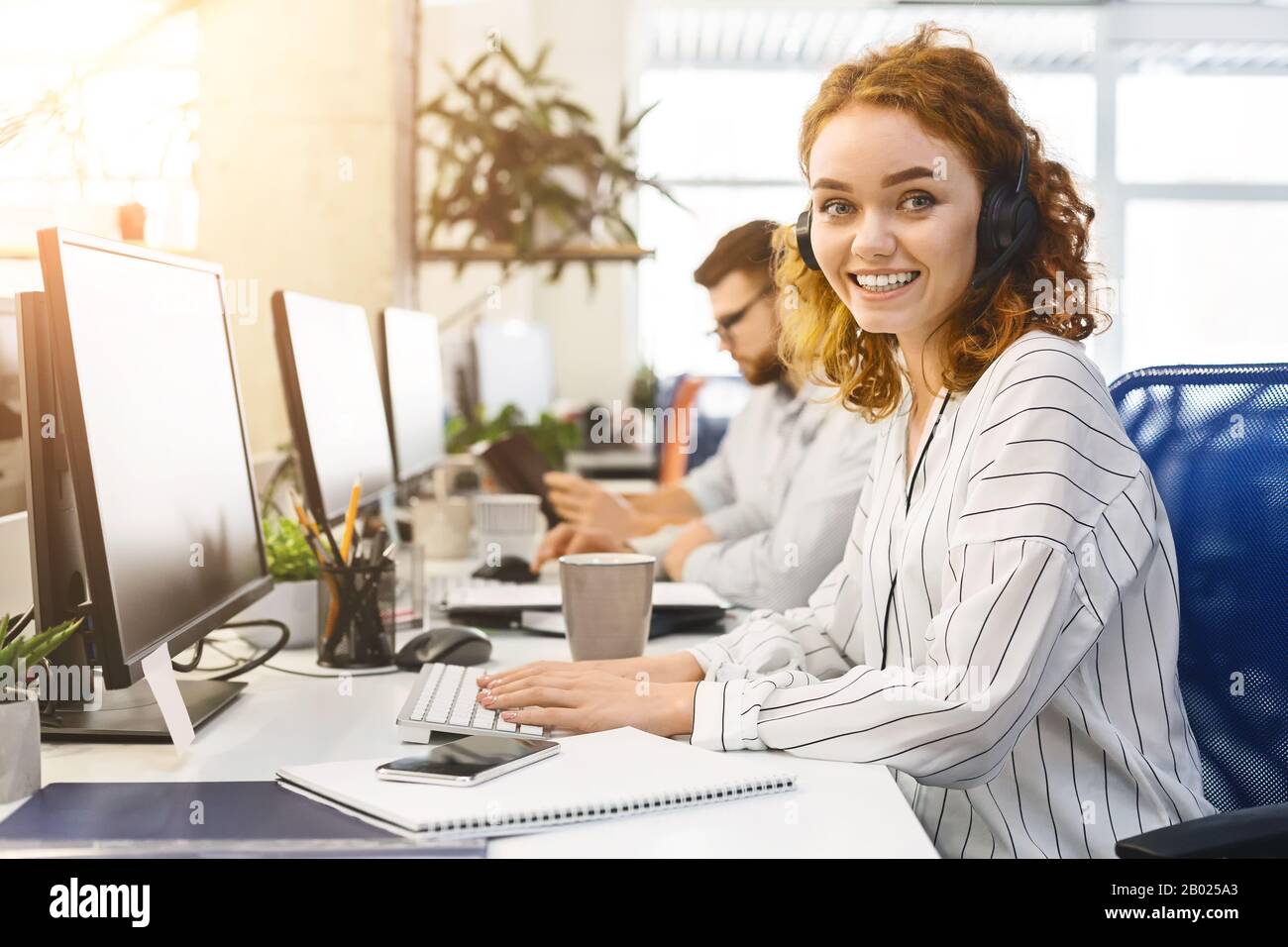 Young business woman working at call center office Stock Photo