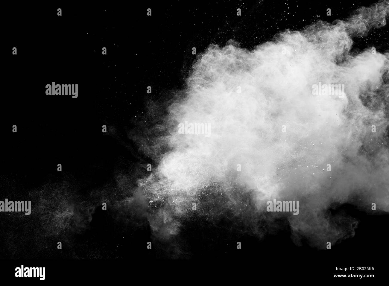 Freeze motion of white dust particles splash on black background.White powder explosion clouds. Stock Photo