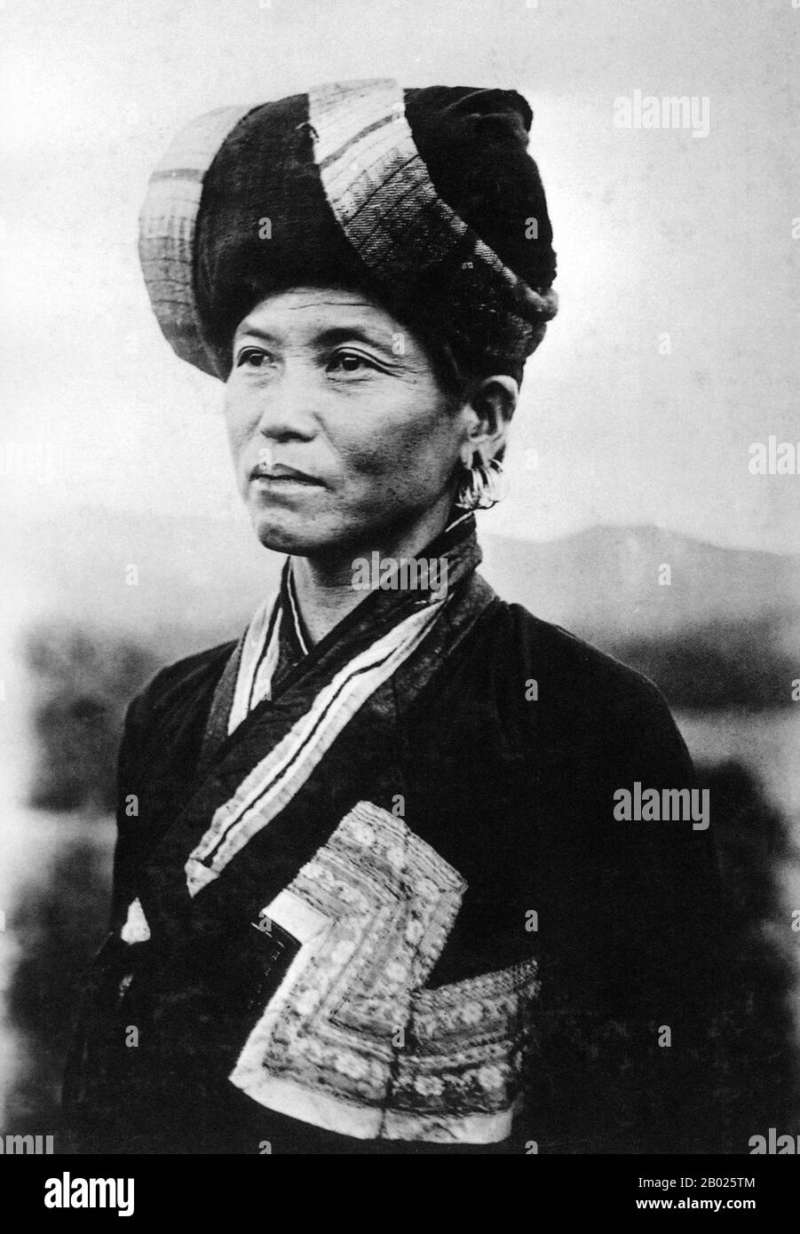 Laos: Tai Lu woman of Muang Sing (Muong Sing), c. 1920.  The Tai ethnicity refers collectively to the ethnic groups of southern China and Southeast Asia, stretching from Hainan to eastern India and from southern Sichuan to Laos, Thailand and parts of Vietnam, which speak languages in the Tai family and share similar traditions and festivals, including the water festival. Despite never having a unified nation-state of their own, the peoples also have historically shared a vague idea of a 'Siam' nation, corrupted to Shan or Assam in some places. Stock Photo
