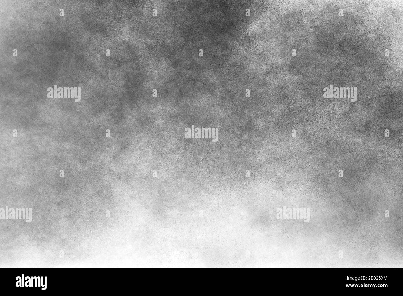 Black powder explosion on white background.Black dust particles splash
