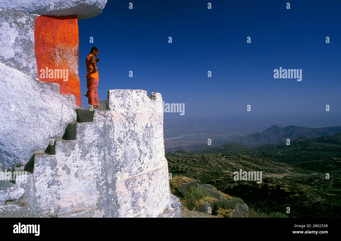 A swami (Sanskrit: स्वामी Svāmi [sʋáːmi]) is an ascetic or yogi who has been initiated into the religious monastic order founded by Adi Shankara, or to a religious teacher.  Mount Abu is a popular hill station in the Aravalli Range in Sirohi district of Rajasthan state in western India near the border with Gujarat. The mountain forms a distinct rocky plateau 22 km long by 9 km wide. The highest peak on the mountain is Guru Shikhar at 1,722 m (5,650 ft) above sea level. It is referred to as 'an oasis in the desert' as its heights are home to rivers, lakes, waterfalls and evergreen forests. Stock Photo