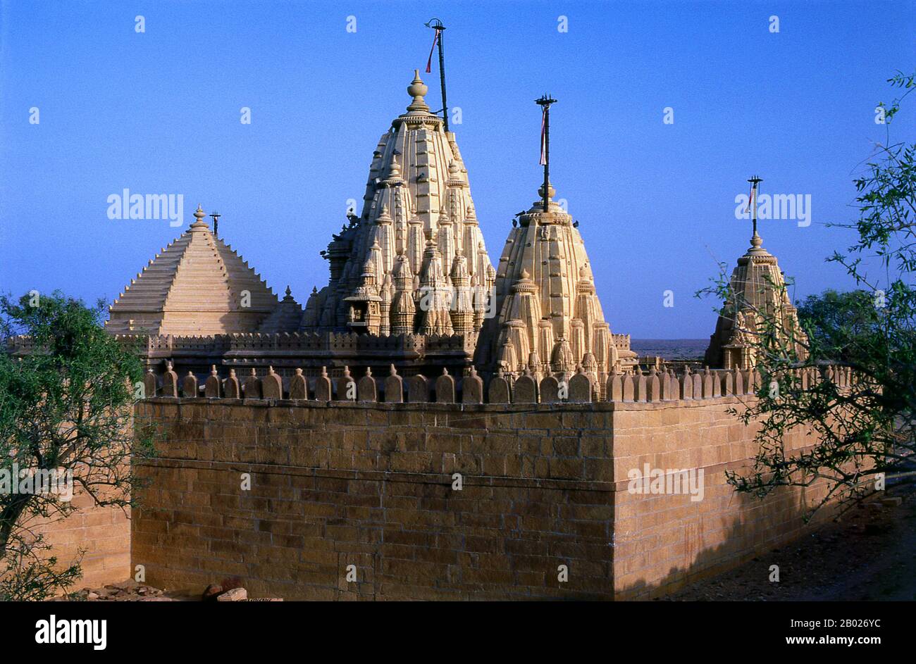 India: Jain temple of Lodhruva (Lodurva) in the Thar Desert near Jaisalmer.  Lodrawa (Lodrawa, Lodurva or Lodarva) situated 15 km to the north-west of Jaisalmer, was the ancient capital of the Bhatti dynasty until 1156 CE, when Rawal Jaisal shifted the capital to Jaisalmer.  The majority of Jaisalmer's inhabitants are Bhati Rajputs, who take their name from an ancestor named Bhatti, a renowned warrior when the tribe were still located in the Punjab. Shortly after this the clan was driven southwards, and found a refuge in the Indian desert, which was henceforth its home. Stock Photo