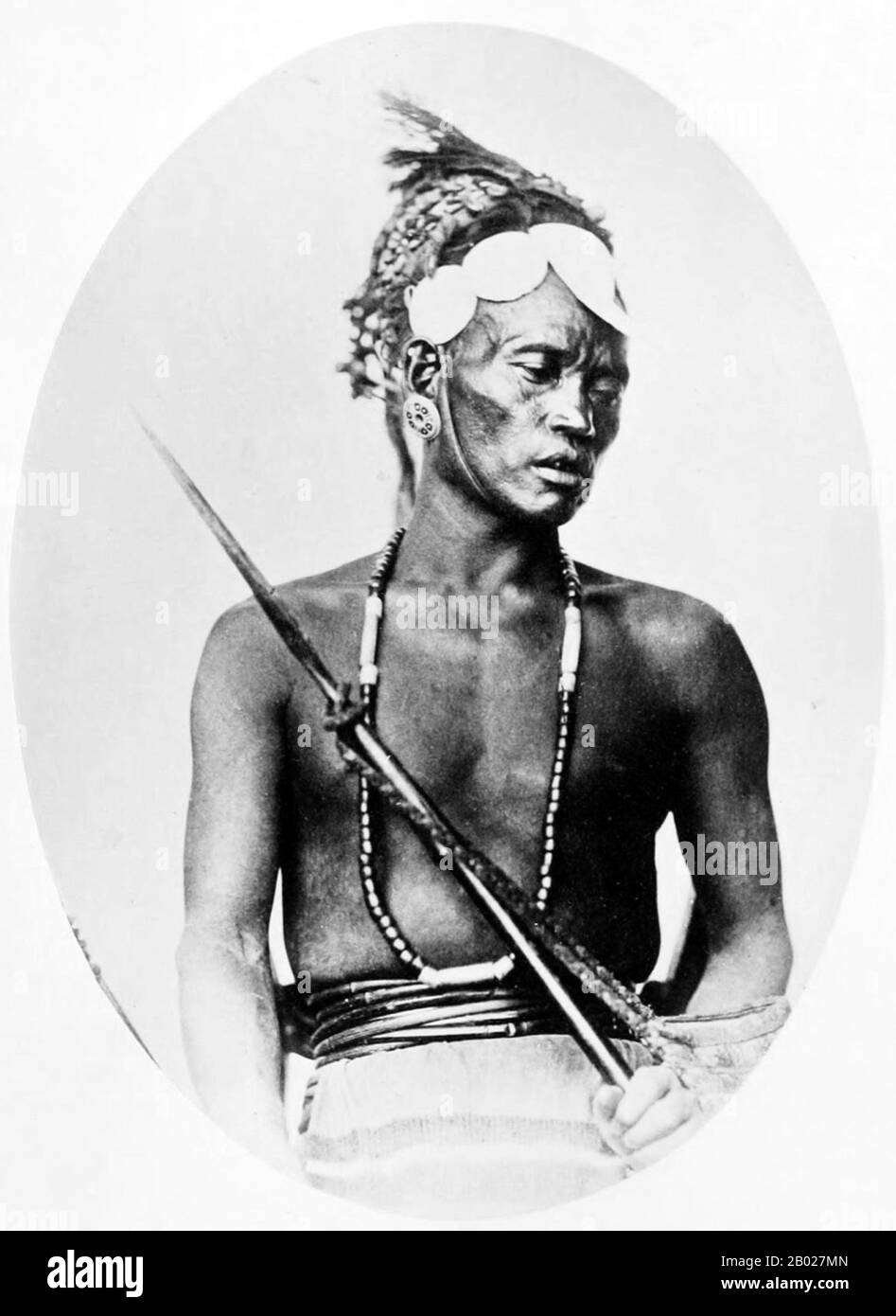 India: 'Marauding Tribe: Rengma Naga, Assam'. Early British colonial photograph, 1868-1875.  The term Naga people refers to a conglomeration of several tribes inhabiting the North Eastern part of India and north-western Burma. The tribes have similar cultures and traditions, and form the majority ethnic group in the Indian states of Nagaland, Manipur, Arunachal Pradesh and Assam.  The Naga speak various distinct languages, which each belong to branches of Tibeto-Burman, including Angami–Pochuri, Ao, Kukish, Sal, Tangkhul and Zeme. Stock Photo